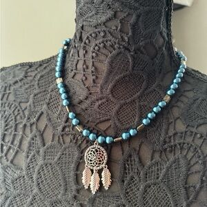 Handmade blue bead necklace with dream catcher bead.